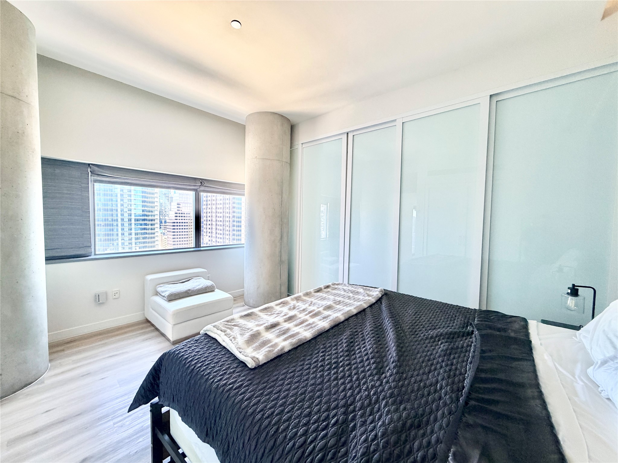 210 Lavaca Street, Unit 1912 Austin, TX 78701 - Photo 18 of 40 Bedroom featuring wood finished floors and baseboards