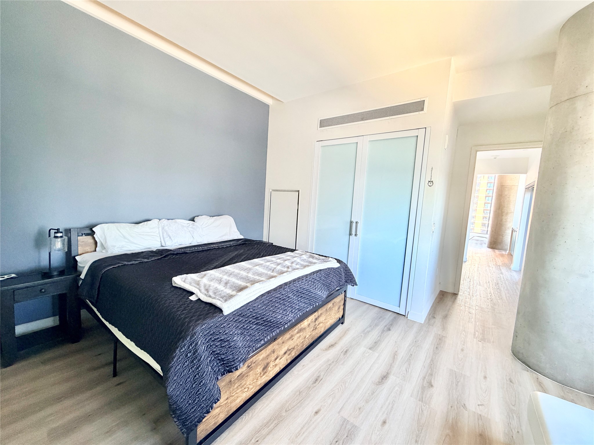 210 Lavaca Street, Unit 1912 Austin, TX 78701 - Photo 20 of 40 Bedroom featuring light wood-type flooring and a closet
