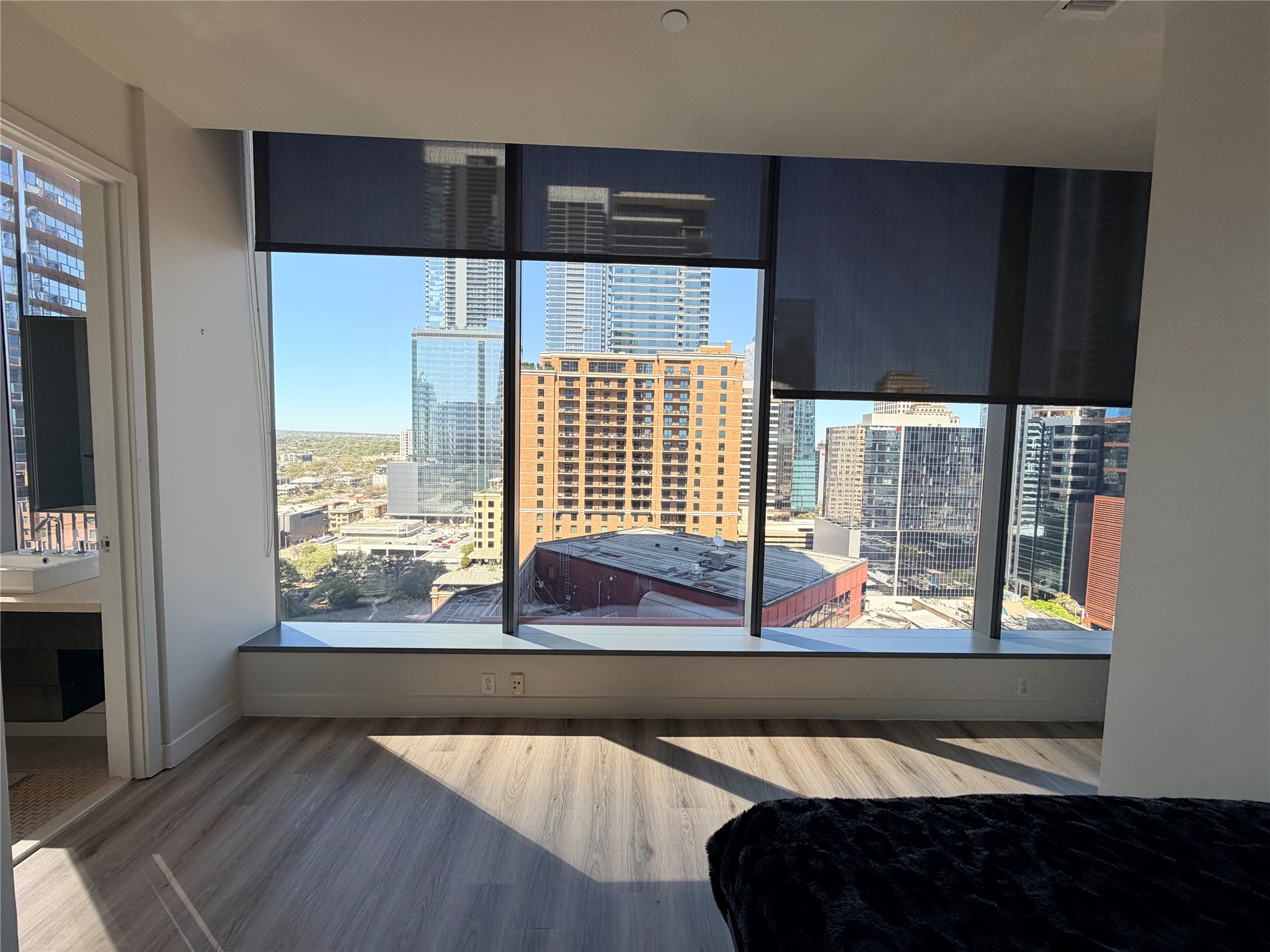 210 Lavaca Street, Unit 1912 Austin, TX 78701 - Photo 26 of 40 Bedroom featuring wood finished floors and a view of city