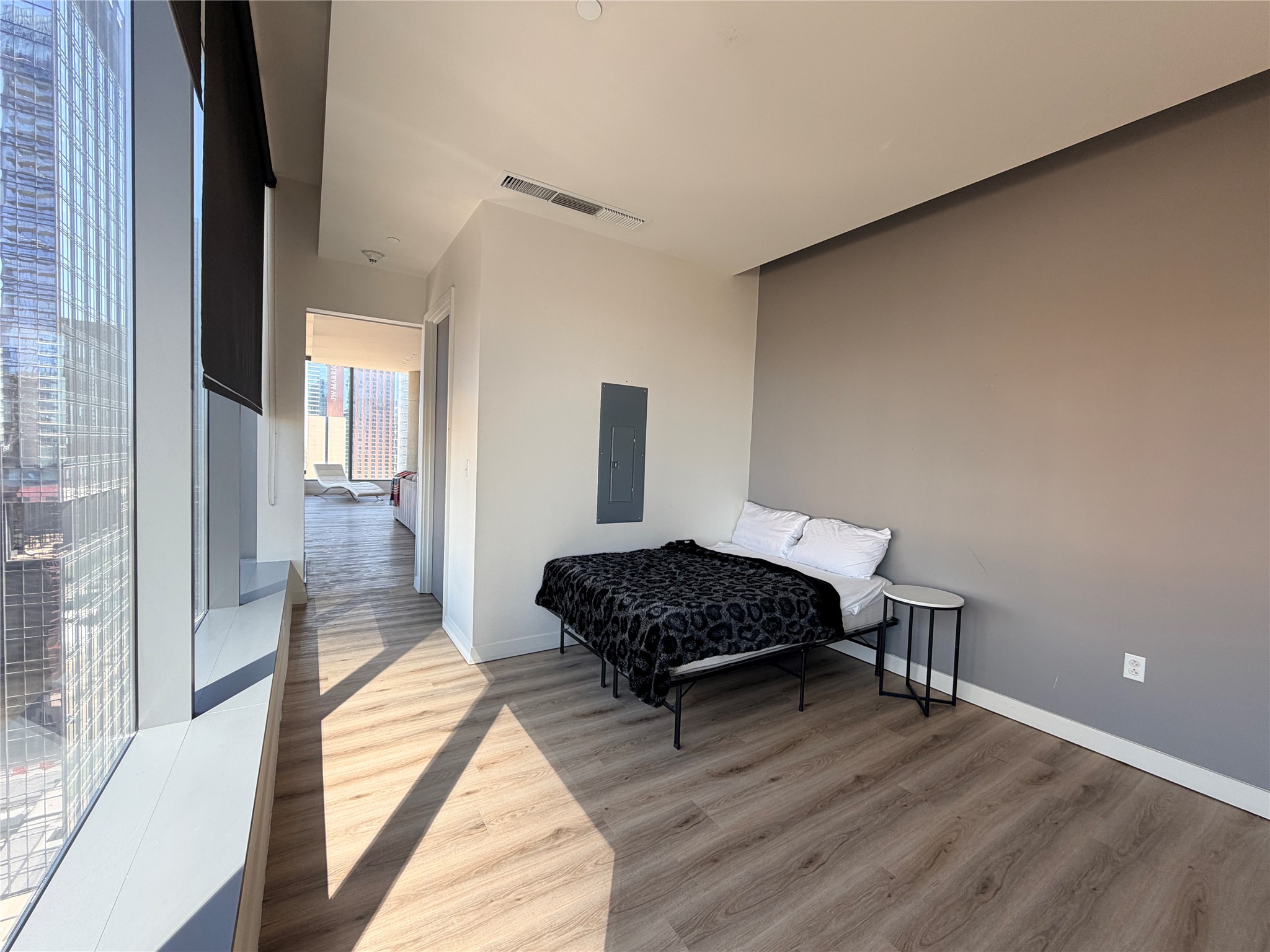 210 Lavaca Street, Unit 1912 Austin, TX 78701 - Photo 27 of 40 Bedroom with light wood-type flooring and electric panel