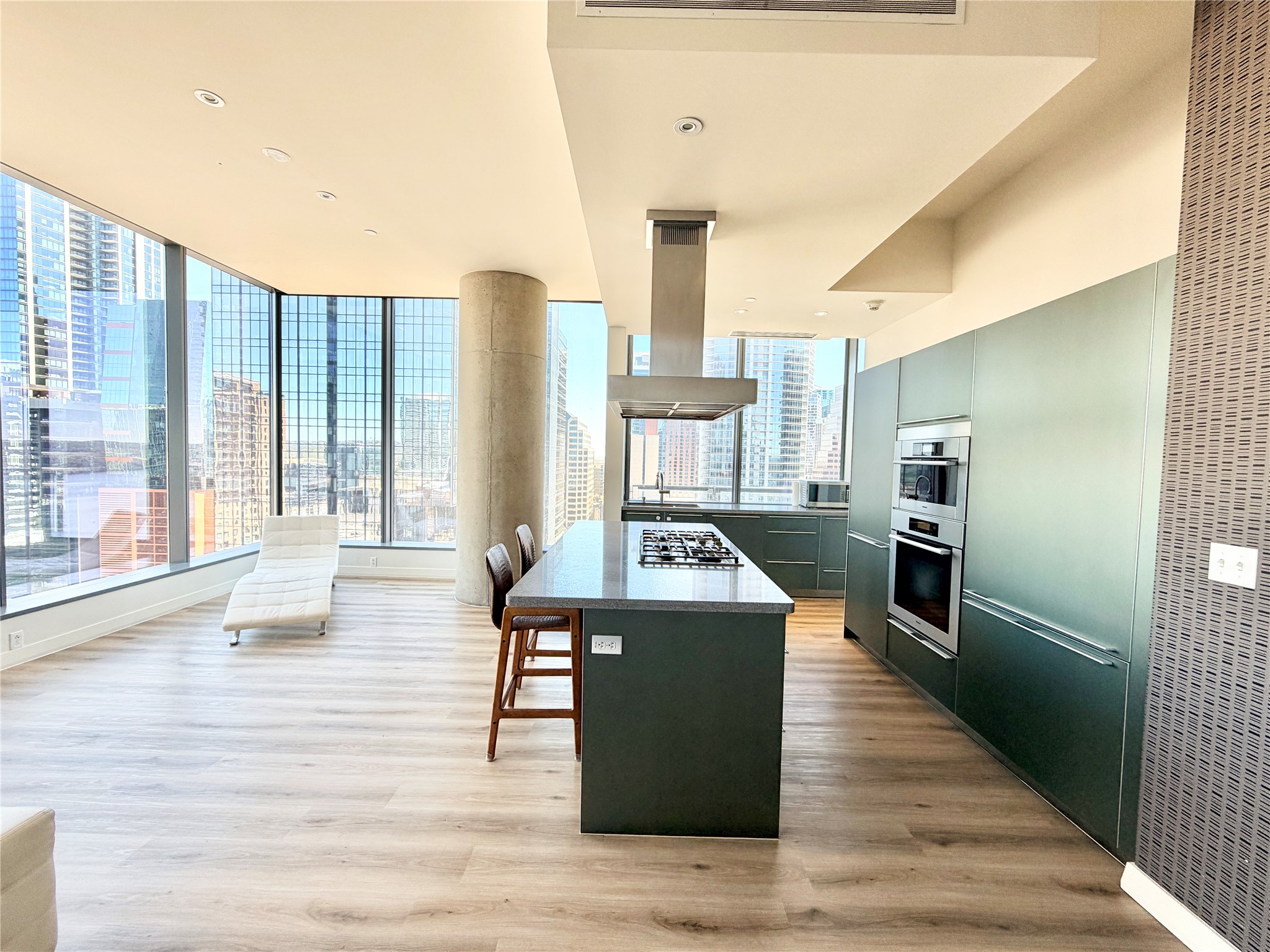 210 Lavaca Street, Unit 1912 Austin, TX 78701 - Photo 6 of 40 Kitchen with a heating unit, a kitchen breakfast bar, a kitchen island, a view of city, and island range hood