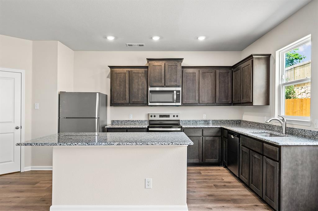 6359 Racer Smt Drive Dallas, TX 75241 - Photo 12 of 20 a kitchen with stainless steel appliances granite countertop a sink stove microwave and refrigerator