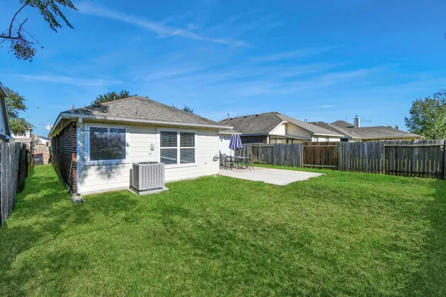 a front view of a house with yard and green space
