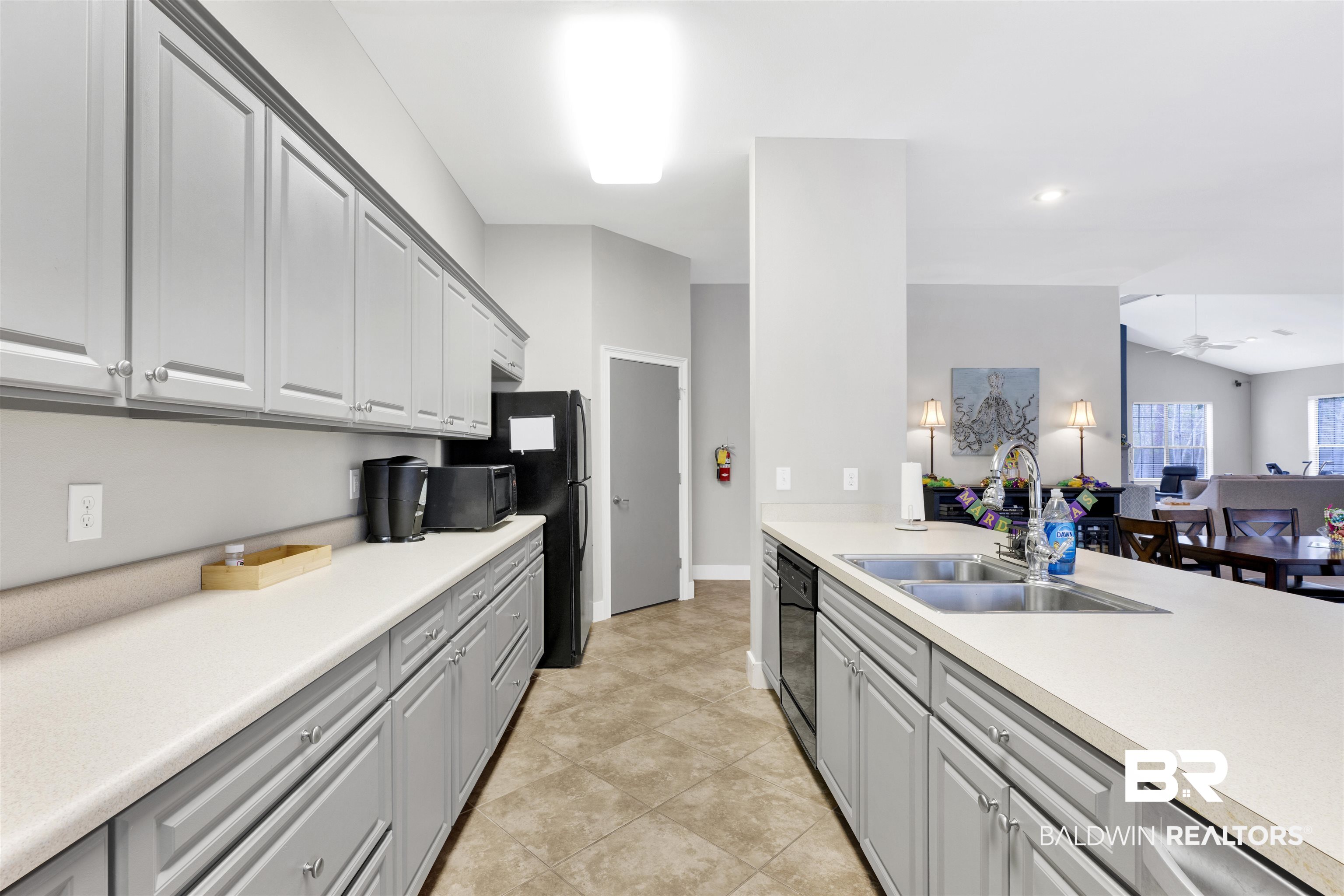 4650 Griffith Marina Road, Unit LOT 24 Orange Beach, AL 36561 - Photo 34 of 34 Kitchen featuring light countertops, open floor plan, gray cabinets, black appliances, and vaulted ceiling