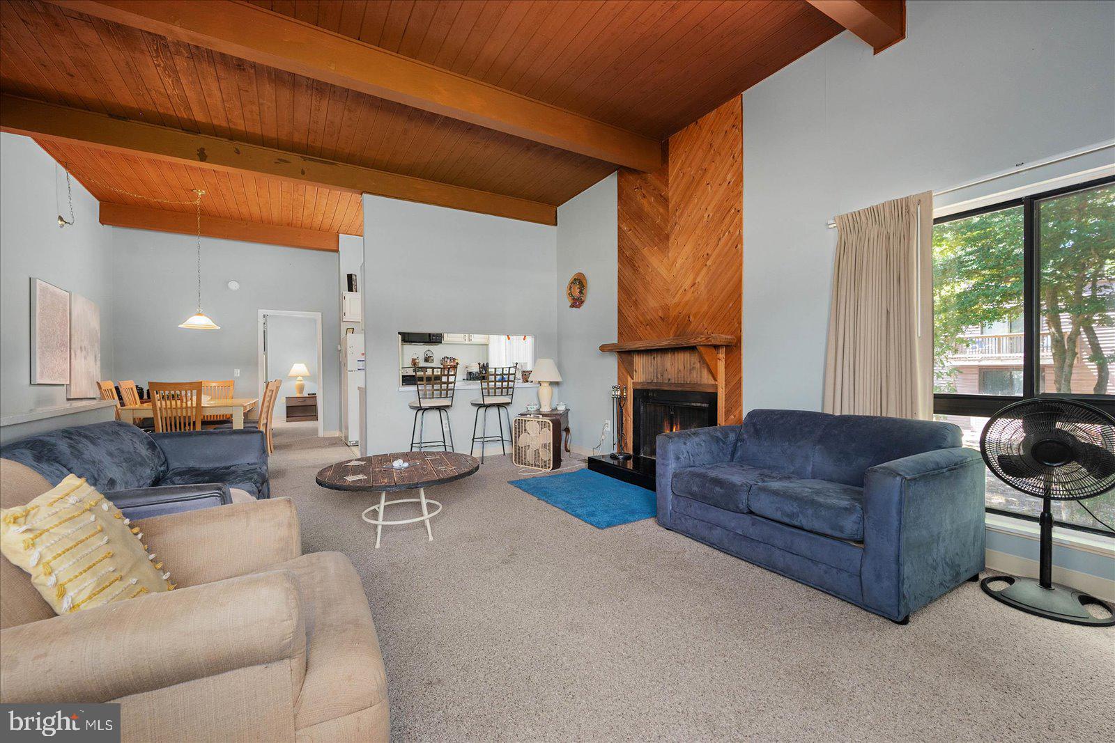 438 Ocean Parkway, Unit 35 Ocean Pines, MD 21811 - Photo 11 of 99 a living room with furniture a fireplace and a table