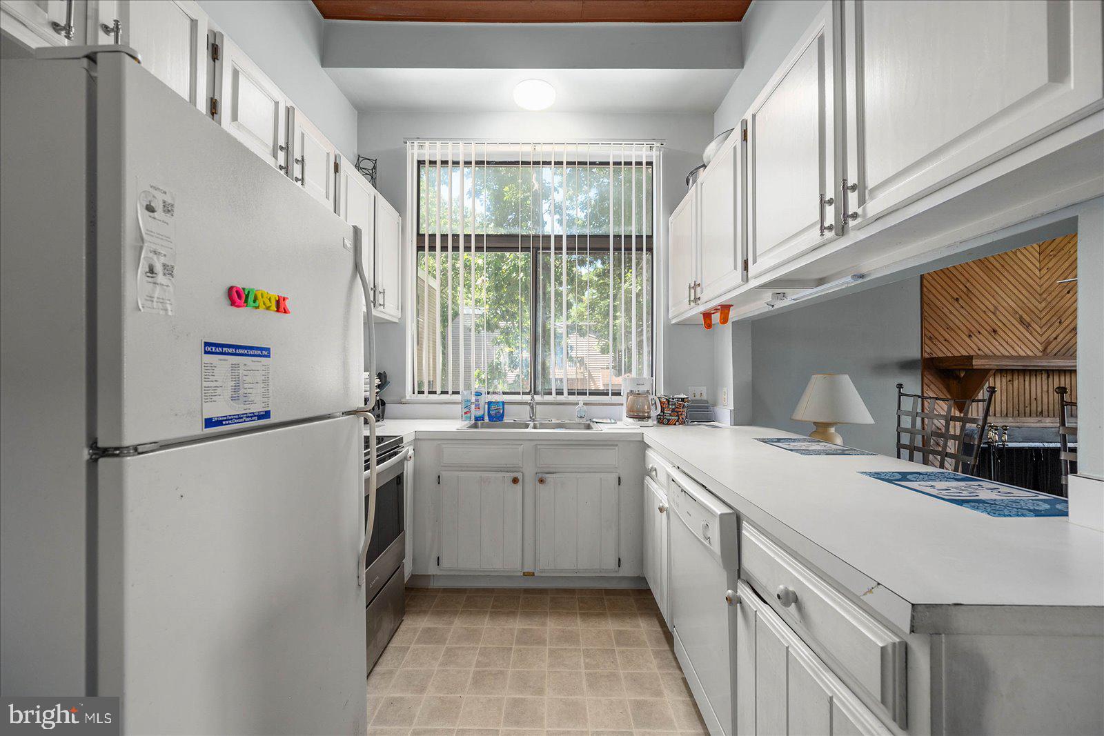 438 Ocean Parkway, Unit 35 Ocean Pines, MD 21811 - Photo 13 of 99 a kitchen with a sink a refrigerator and window