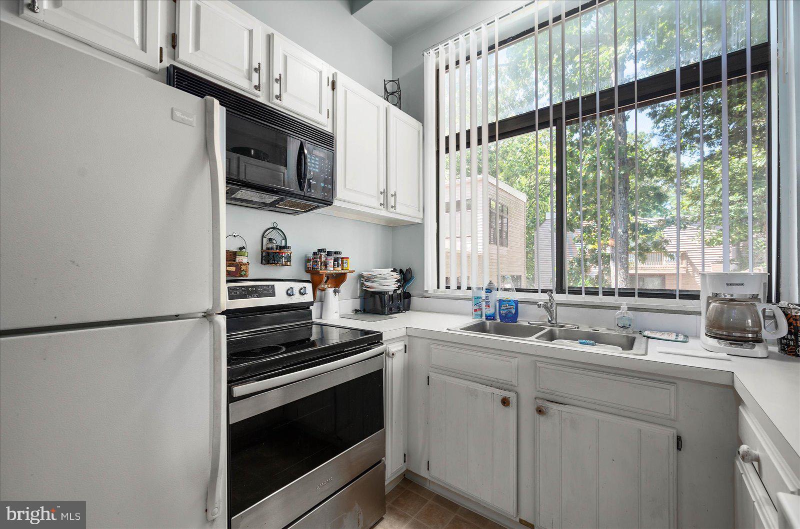 438 Ocean Parkway, Unit 35 Ocean Pines, MD 21811 - Photo 14 of 99 a kitchen with stainless steel appliances white cabinets and a stove top oven