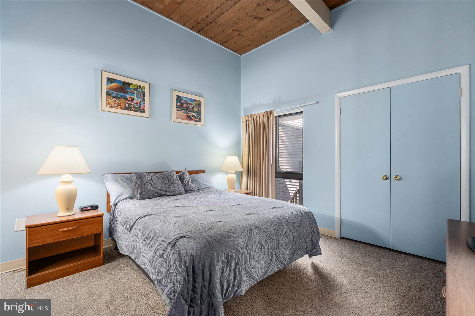 438 Ocean Parkway, Unit 35 Ocean Pines, MD 21811 - Photo 17 of 99 a bedroom with a bed and a lamp