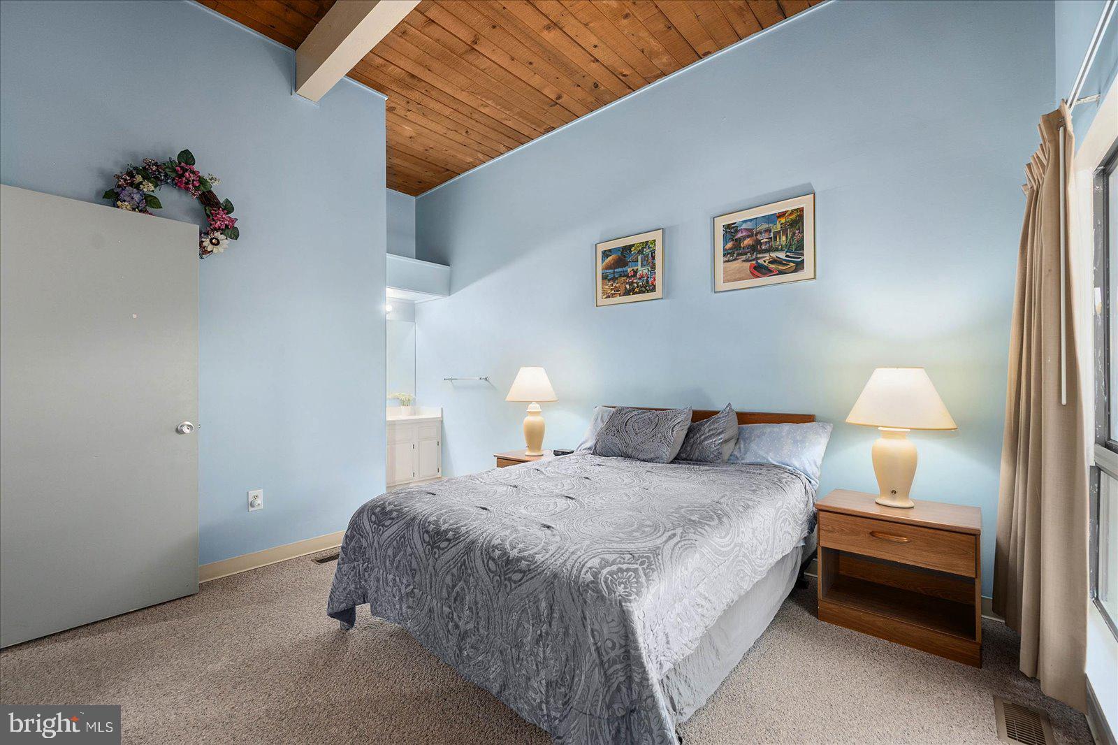 438 Ocean Parkway, Unit 35 Ocean Pines, MD 21811 - Photo 19 of 99 a bedroom with a bed and a lamp on the dresser