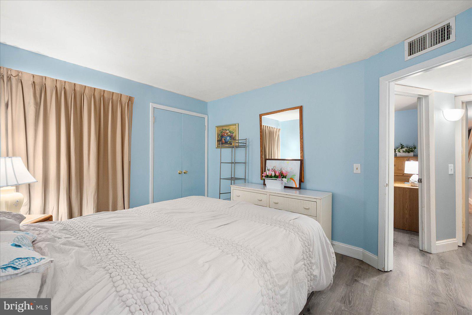 438 Ocean Parkway, Unit 35 Ocean Pines, MD 21811 - Photo 23 of 99 a bedroom with a large bed and a chandelier