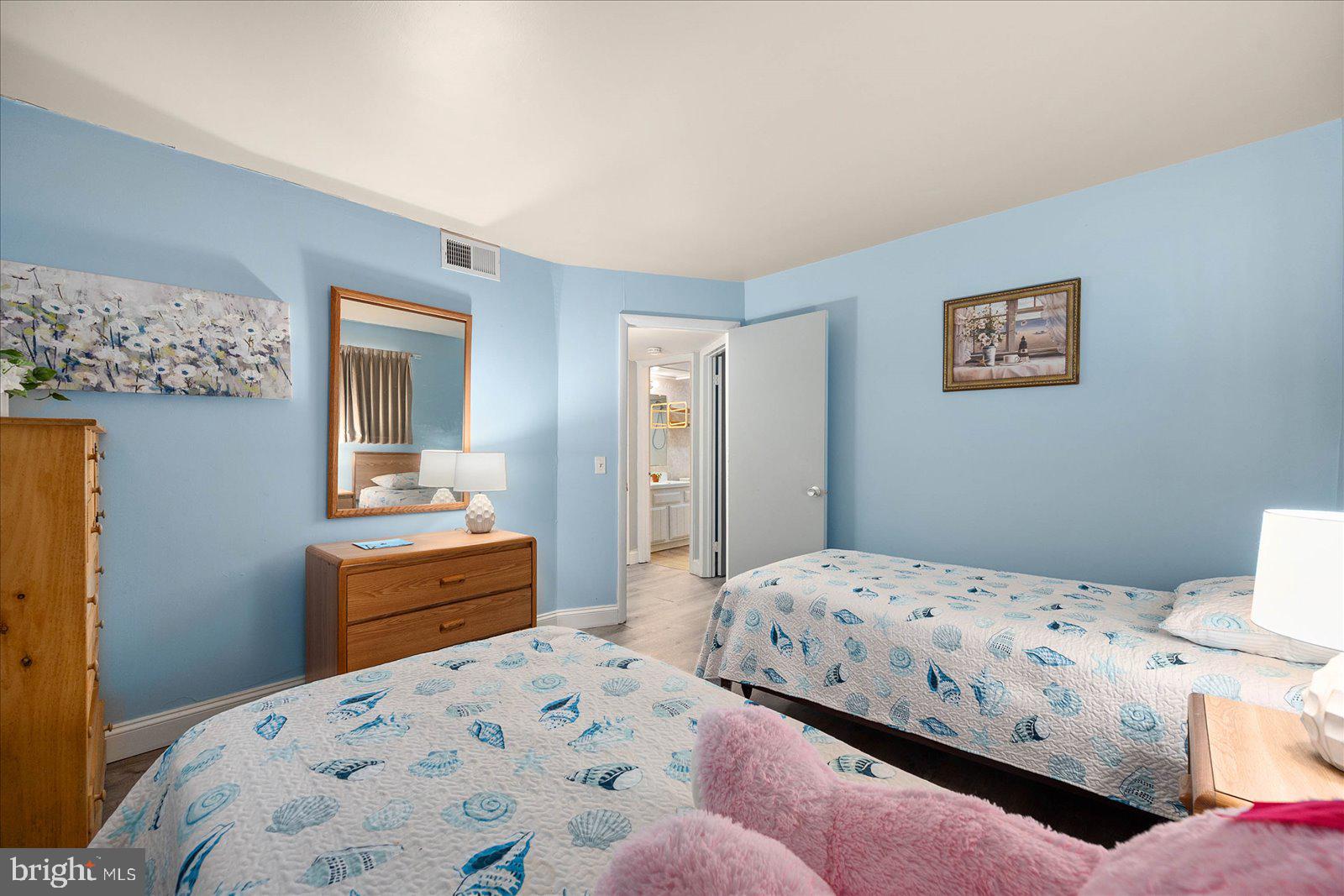 438 Ocean Parkway, Unit 35 Ocean Pines, MD 21811 - Photo 28 of 99 a bedroom with a bed and dresser