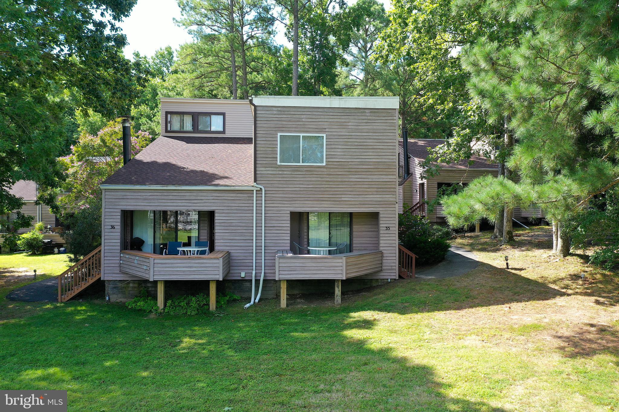 438 Ocean Parkway, Unit 35 Ocean Pines, MD 21811 - Photo 47 of 99 a front view of a house with a garden