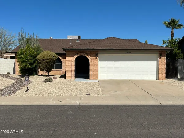 a view of a house with a yard and garage