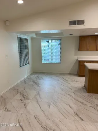 a view of empty room with window and fireplace