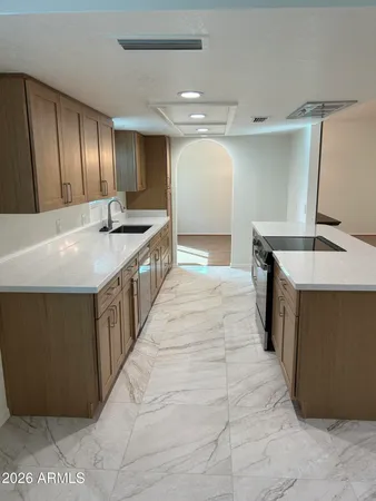 a large kitchen with kitchen island a sink stove and refrigerator