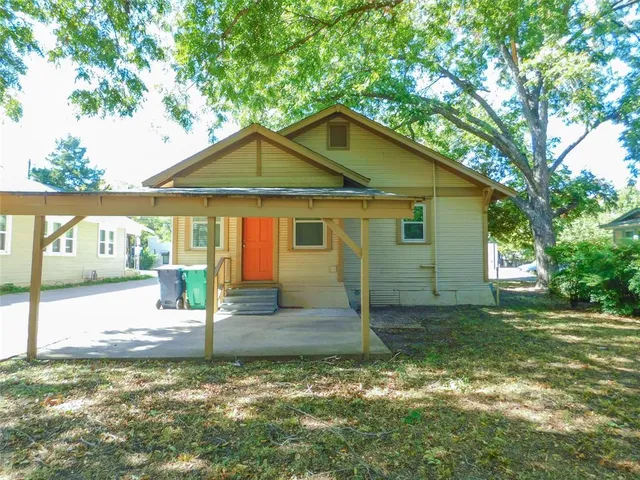 a view of a yard with large trees