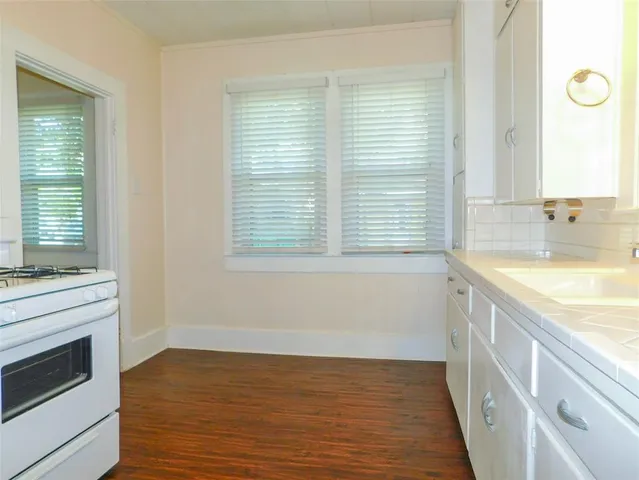 a view of a kitchen with a sink dishwasher and a fireplace