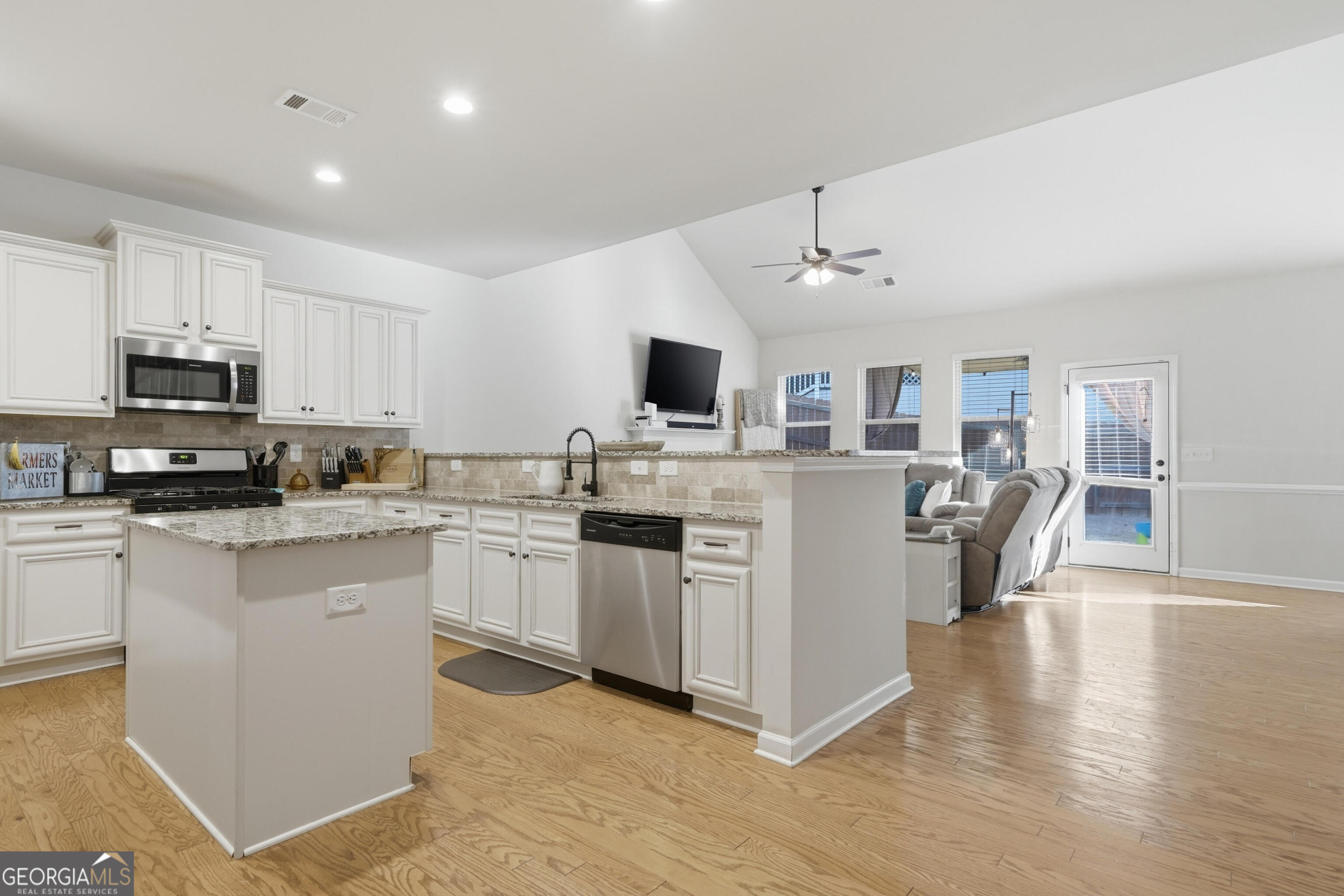 301 Stoney Hollow Road Canton, GA 30114 - Photo 18 of 47 a kitchen with stainless steel appliances granite countertop a stove top oven a sink a dining table and chairs