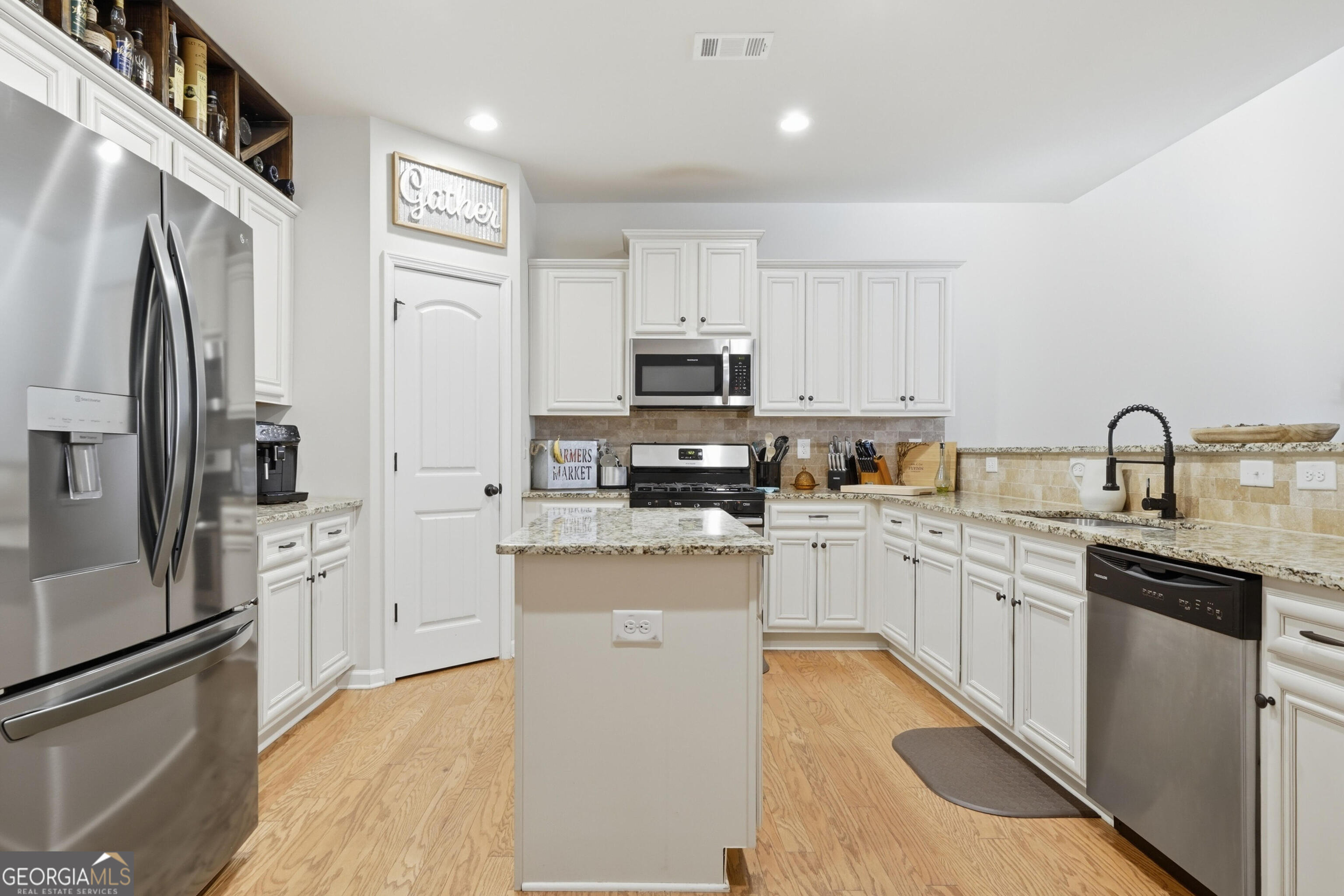 301 Stoney Hollow Road Canton, GA 30114 - Photo 19 of 47 a kitchen with granite countertop a refrigerator sink and microwave