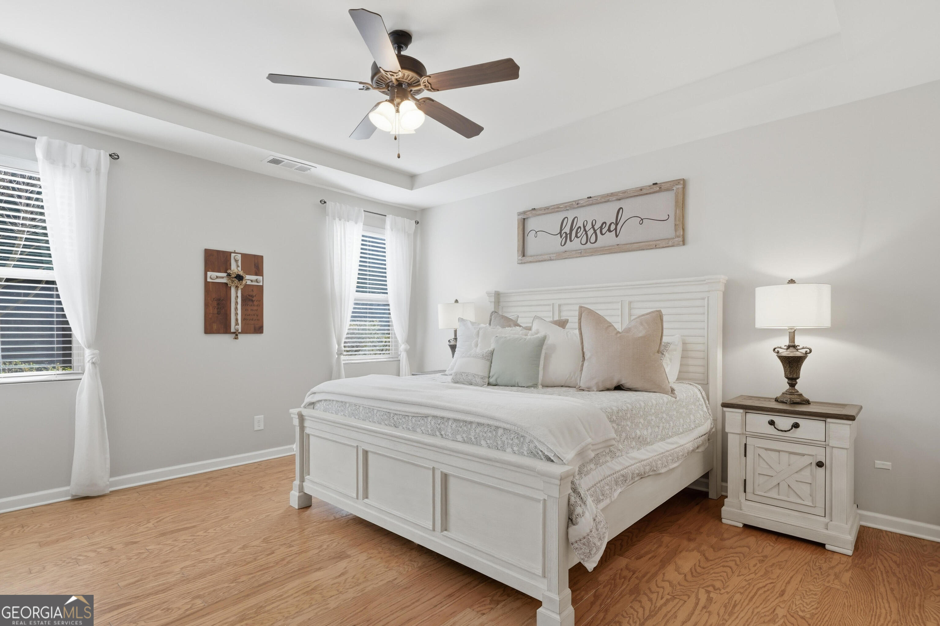 301 Stoney Hollow Road Canton, GA 30114 - Photo 28 of 47 a bedroom with a large bed and a chandelier