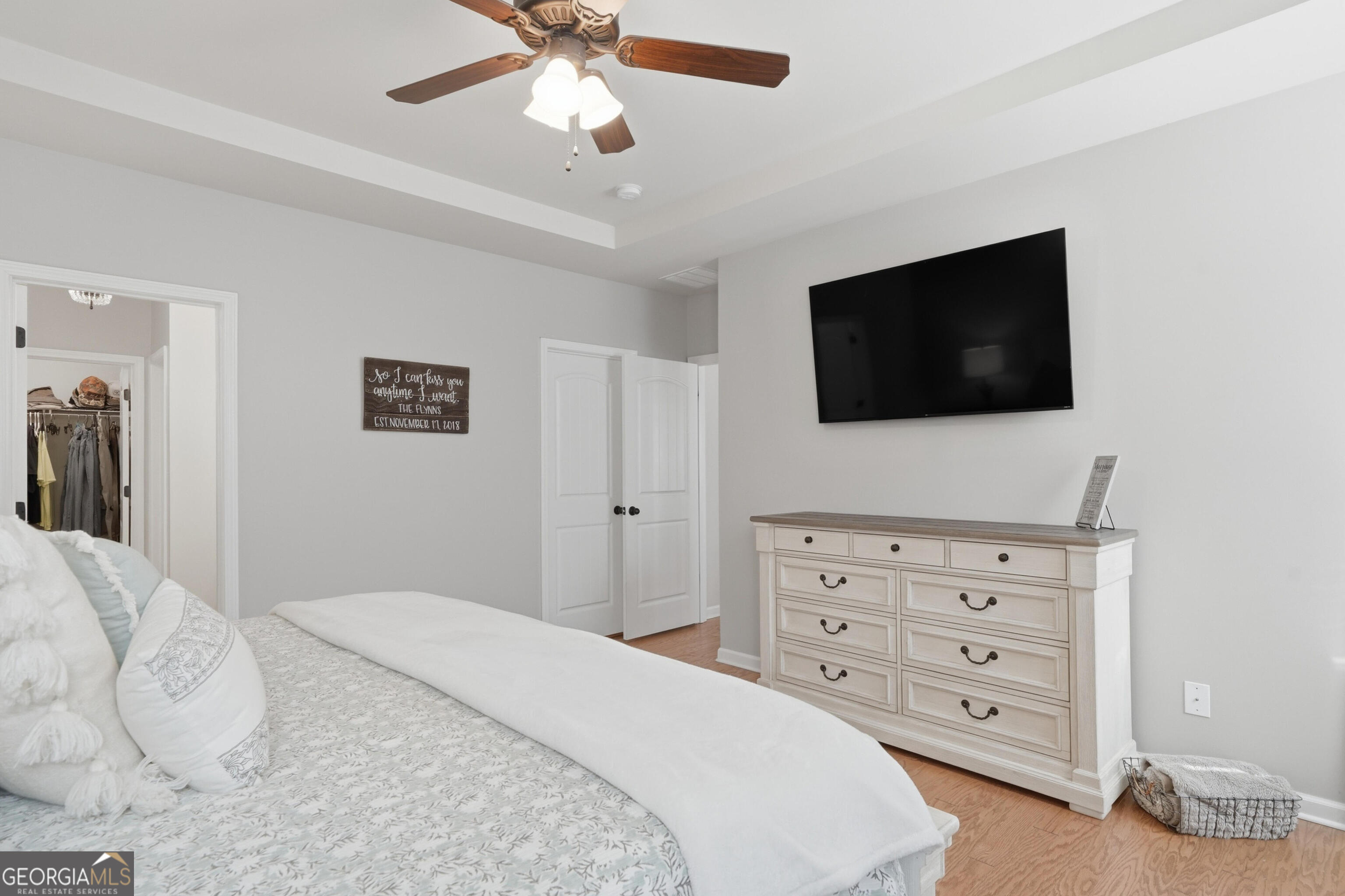 301 Stoney Hollow Road Canton, GA 30114 - Photo 29 of 47 a bedroom with a bed a flat screen tv and a chandelier