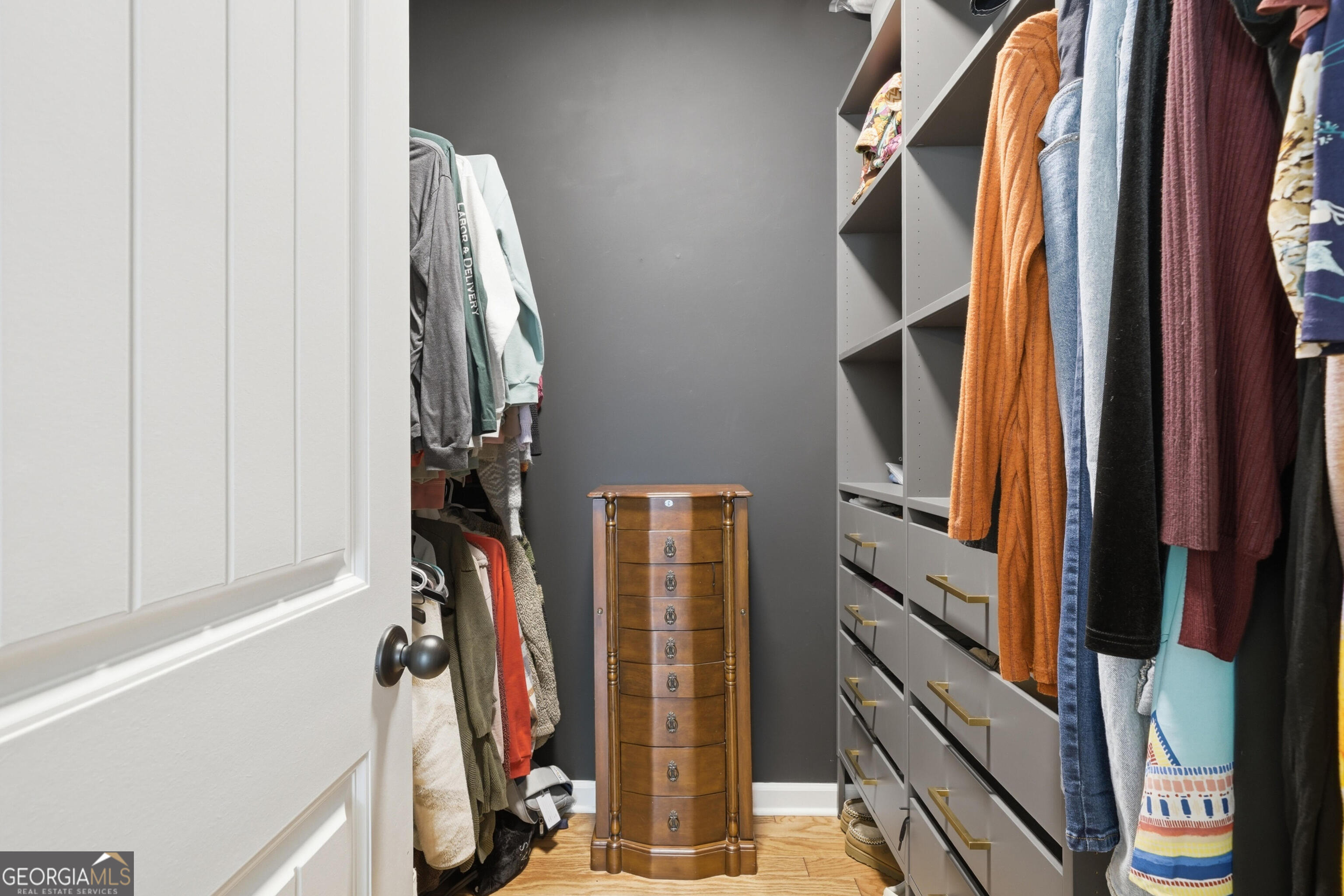 301 Stoney Hollow Road Canton, GA 30114 - Photo 32 of 47 a view of walk in closet with clothes