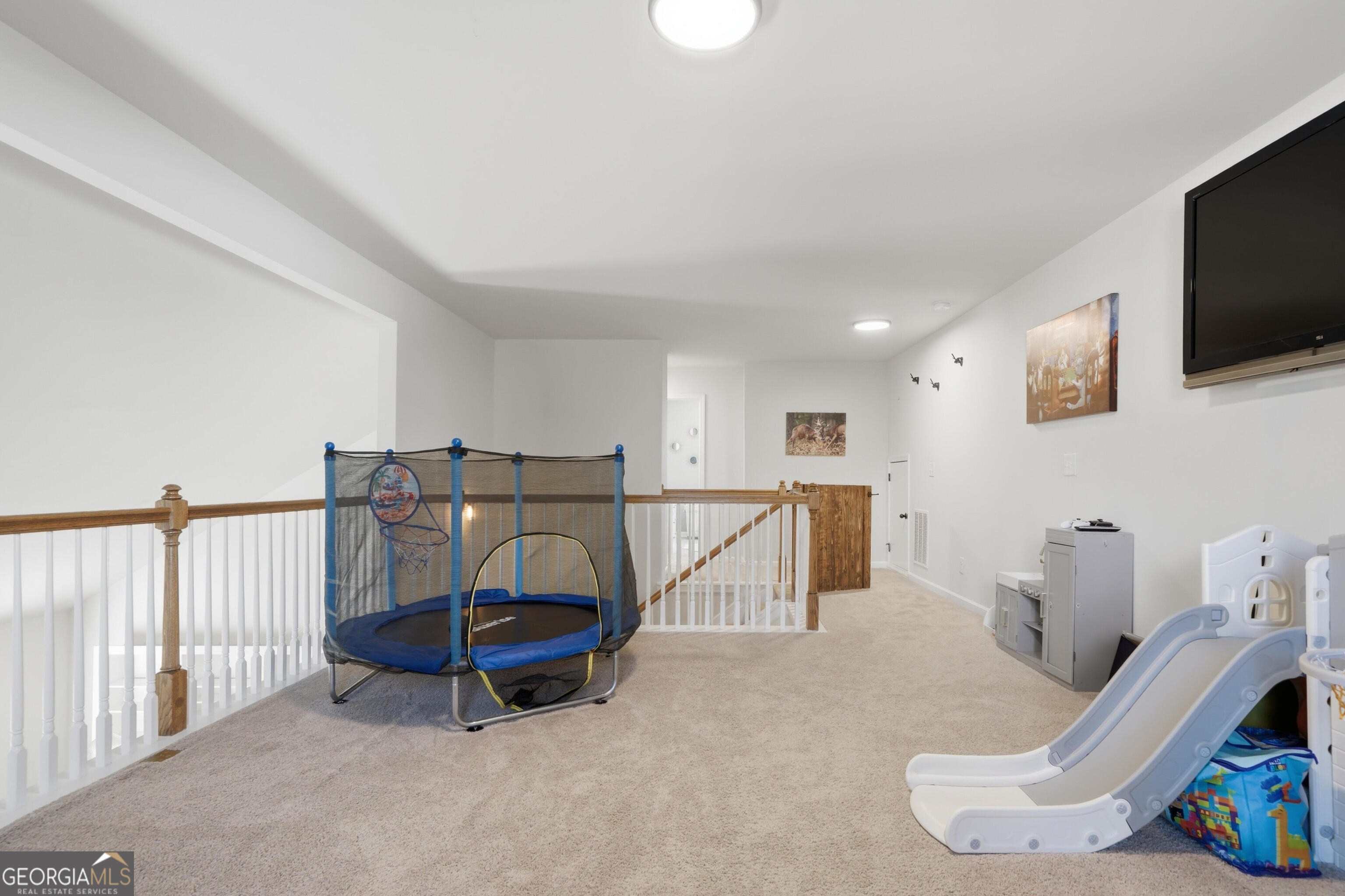301 Stoney Hollow Road Canton, GA 30114 - Photo 36 of 47 a living room with furniture and a flat screen tv