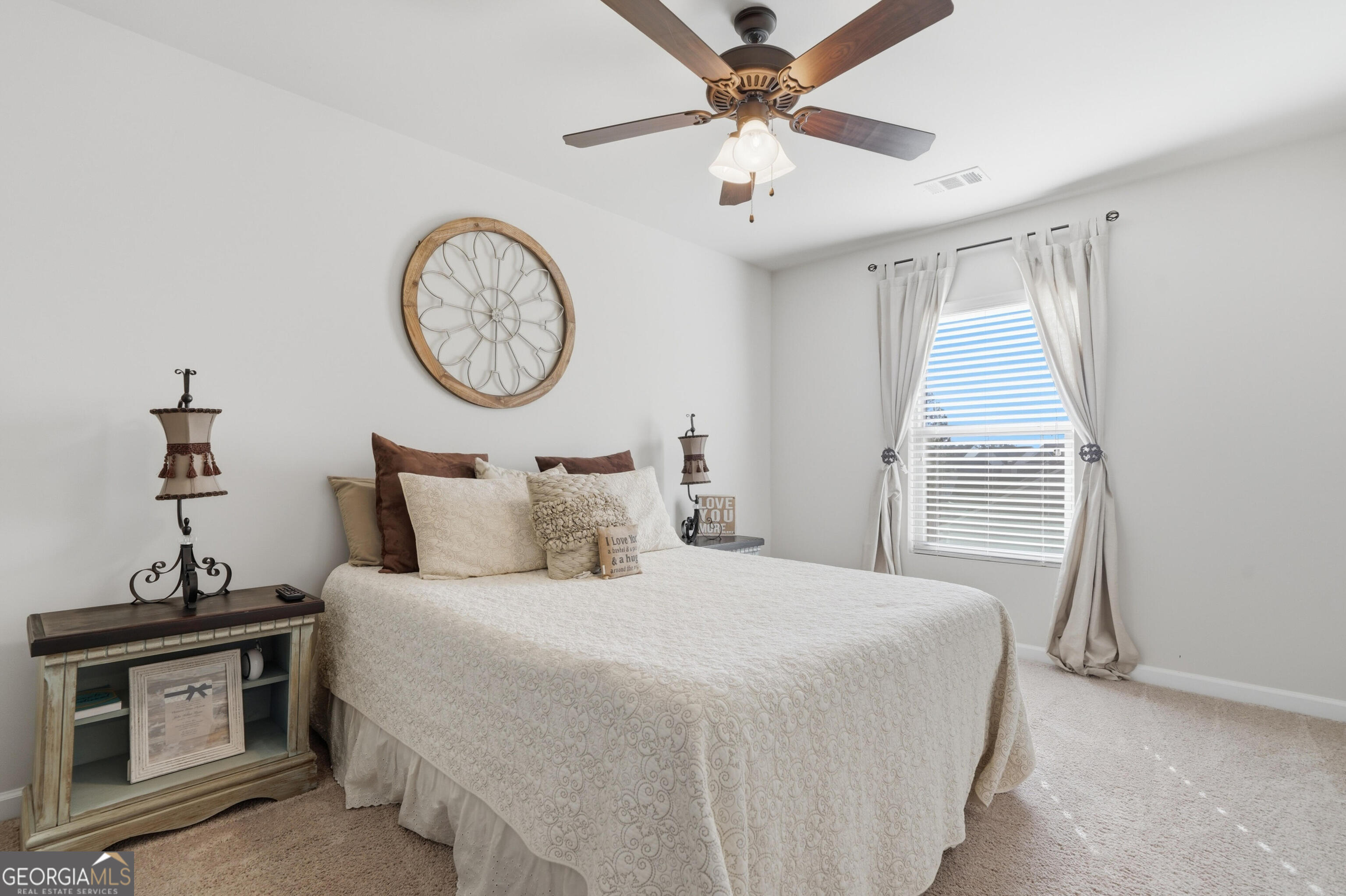 301 Stoney Hollow Road Canton, GA 30114 - Photo 39 of 47 a bedroom with bed and a chandelier