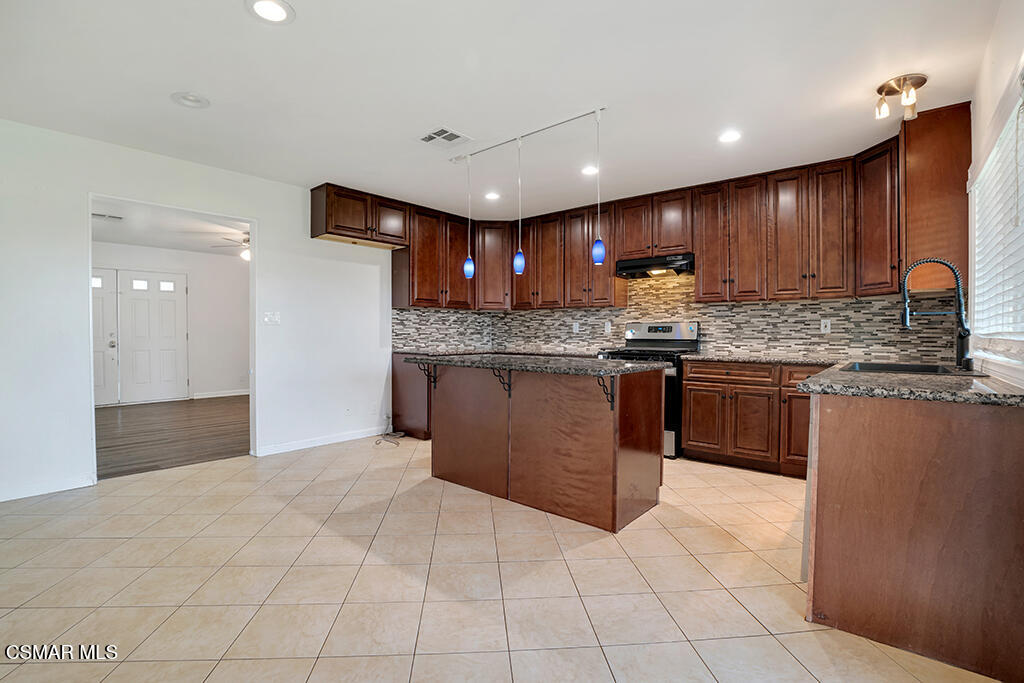 2353 Bryson Place Simi Valley, CA 93065 - Photo 11 of 31 a kitchen with stainless steel appliances granite countertop wooden cabinets a sink and dishwasher