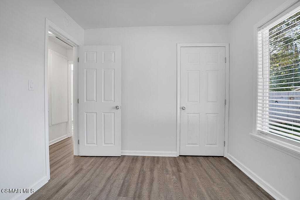 2353 Bryson Place Simi Valley, CA 93065 - Photo 13 of 31 a view of an empty room with wooden floor and a window