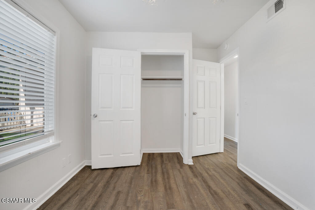 2353 Bryson Place Simi Valley, CA 93065 - Photo 16 of 31 a view of an empty room with wooden floor and a window