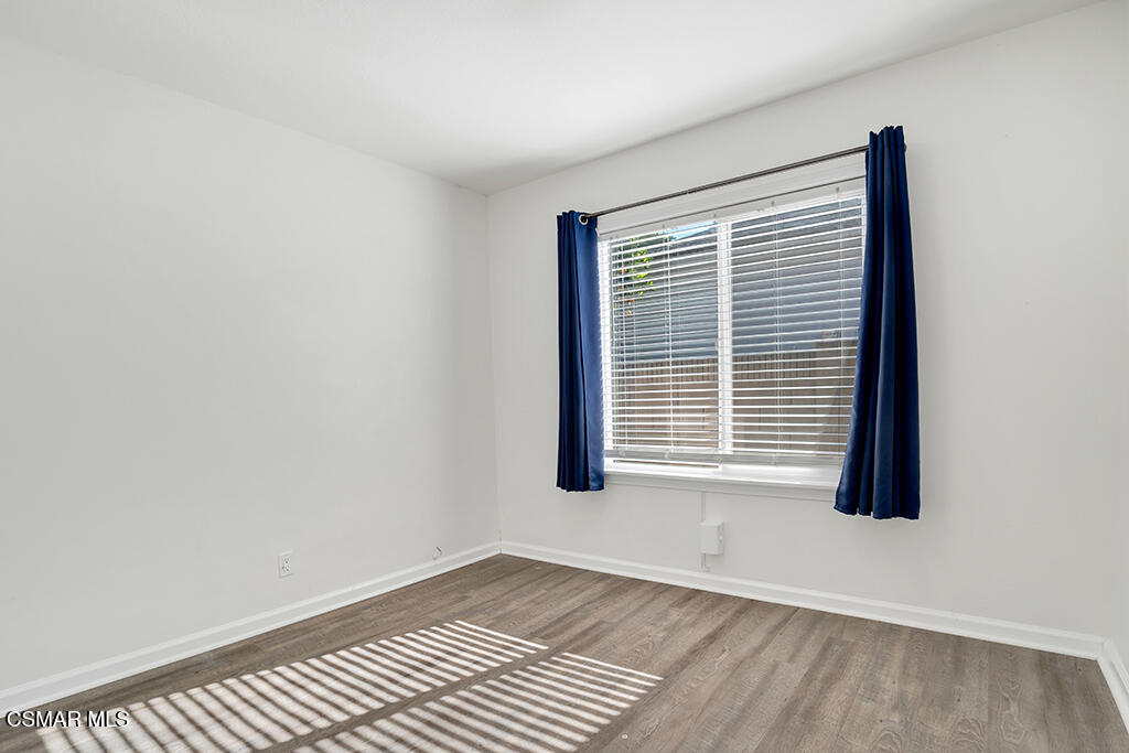 2353 Bryson Place Simi Valley, CA 93065 - Photo 17 of 31 a view of an empty room with wooden floor and a window