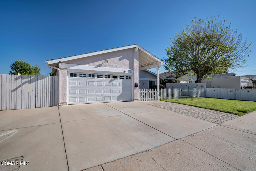 2353 Bryson Place Simi Valley, CA 93065 - Photo 2 of 31 a view of a house with a yard and garage