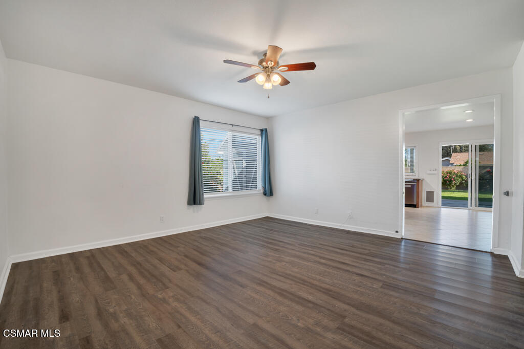 2353 Bryson Place Simi Valley, CA 93065 - Photo 6 of 31 an empty room with wooden floor chandelier fan and windows