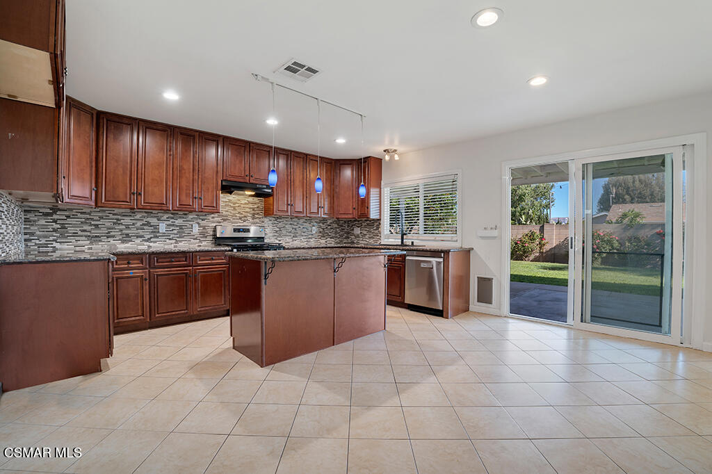 2353 Bryson Place Simi Valley, CA 93065 - Photo 8 of 31 a kitchen with kitchen island granite countertop a stove sink and cabinets