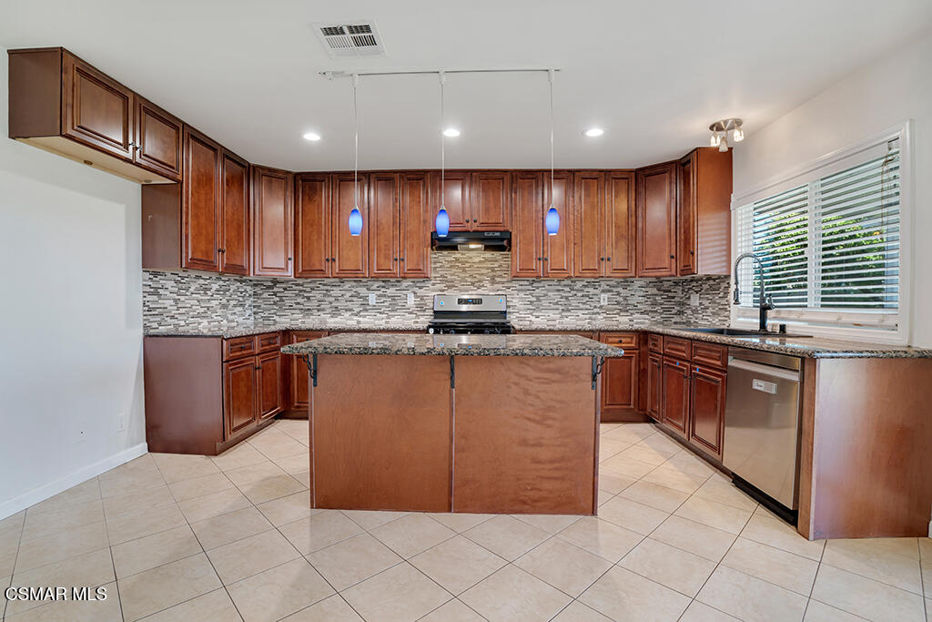 2353 Bryson Place Simi Valley, CA 93065 - Photo 9 of 31 a kitchen with stainless steel appliances granite countertop a stove a sink and a microwave
