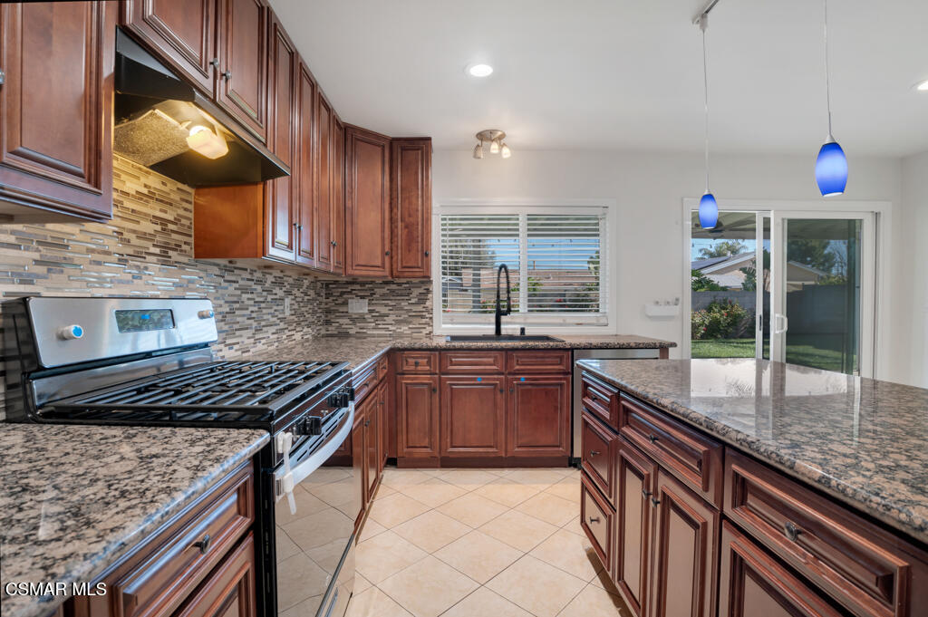 2353 Bryson Place Simi Valley, CA 93065 - Photo 10 of 31 a kitchen with granite countertop a sink and a stove