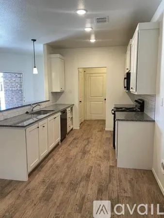 a kitchen with a sink stove and cabinets