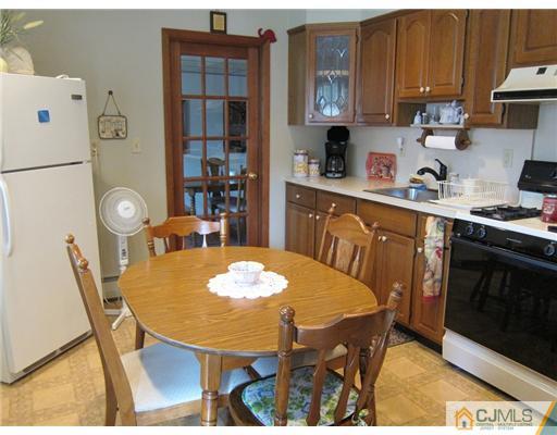 22 Fairfax Road Edison, NJ 08817 - Photo 2 of 8 a kitchen with stainless steel appliances granite countertop a dining table and chairs