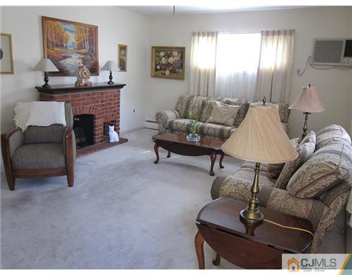 22 Fairfax Road Edison, NJ 08817 - Photo 5 of 8 a living room with furniture and a fireplace