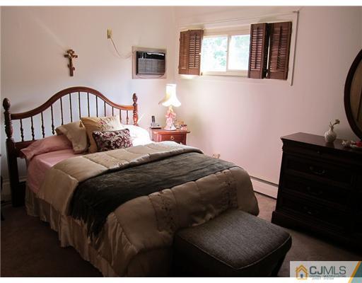 22 Fairfax Road Edison, NJ 08817 - Photo 6 of 8 a bedroom with a bed and wooden floor