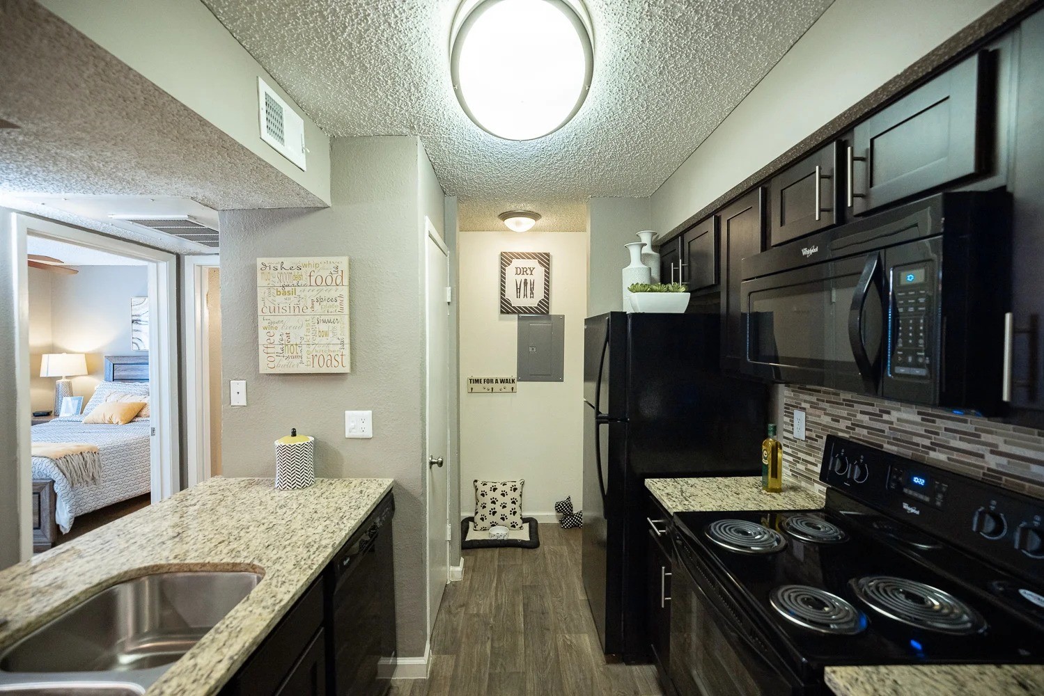 1773 Wells Branch Parkway, Unit 1018 Austin, TX 78728 - Photo 11 of 21 a kitchen with a stove and a wooden floors