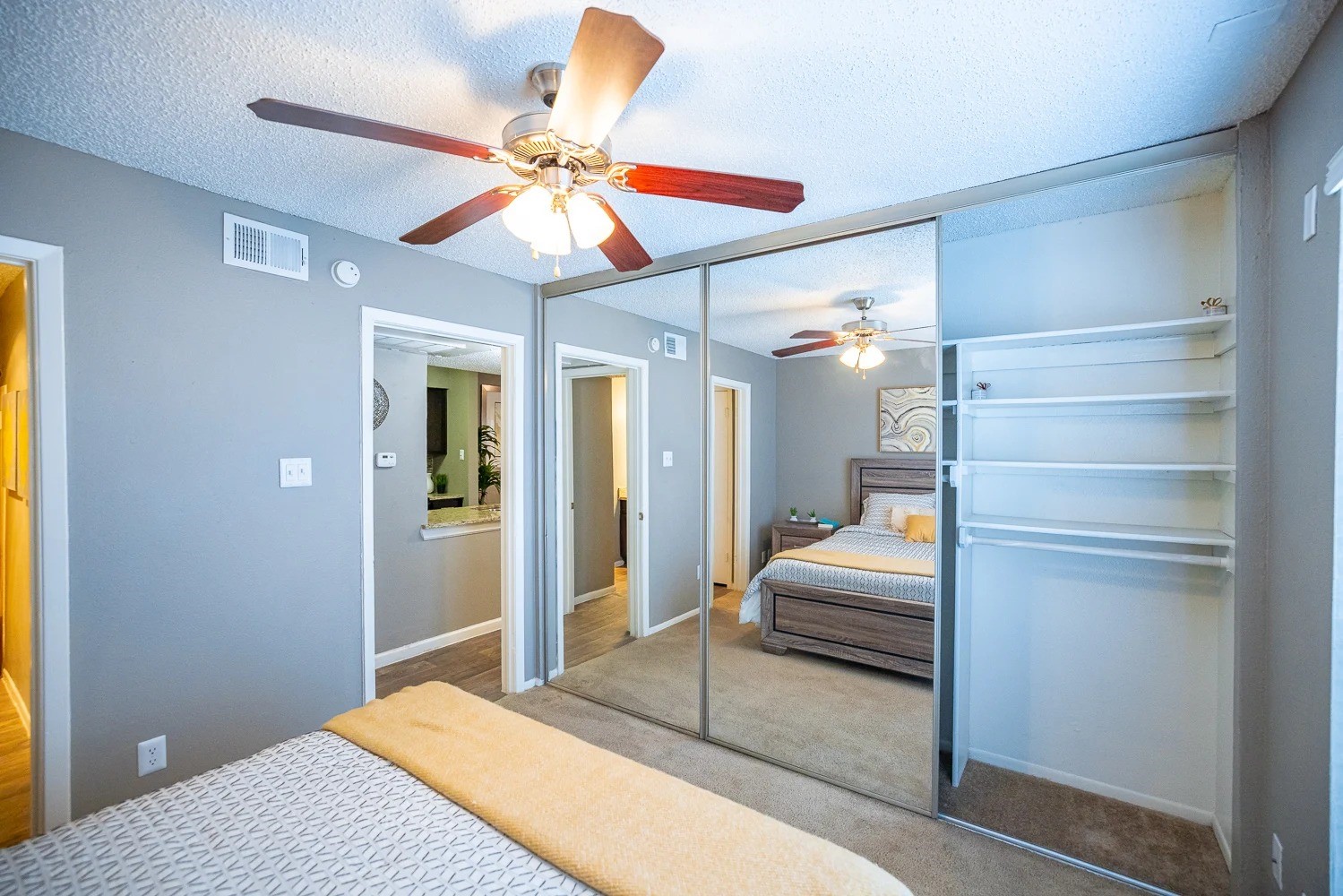 1773 Wells Branch Parkway, Unit 1018 Austin, TX 78728 - Photo 12 of 21 a bedroom with a bed and a chandelier