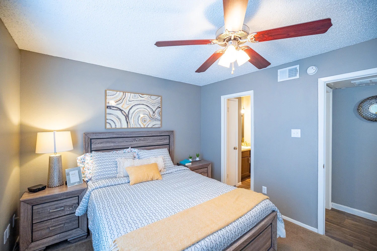 1773 Wells Branch Parkway, Unit 1018 Austin, TX 78728 - Photo 19 of 21 a bedroom with a bed and a chandelier