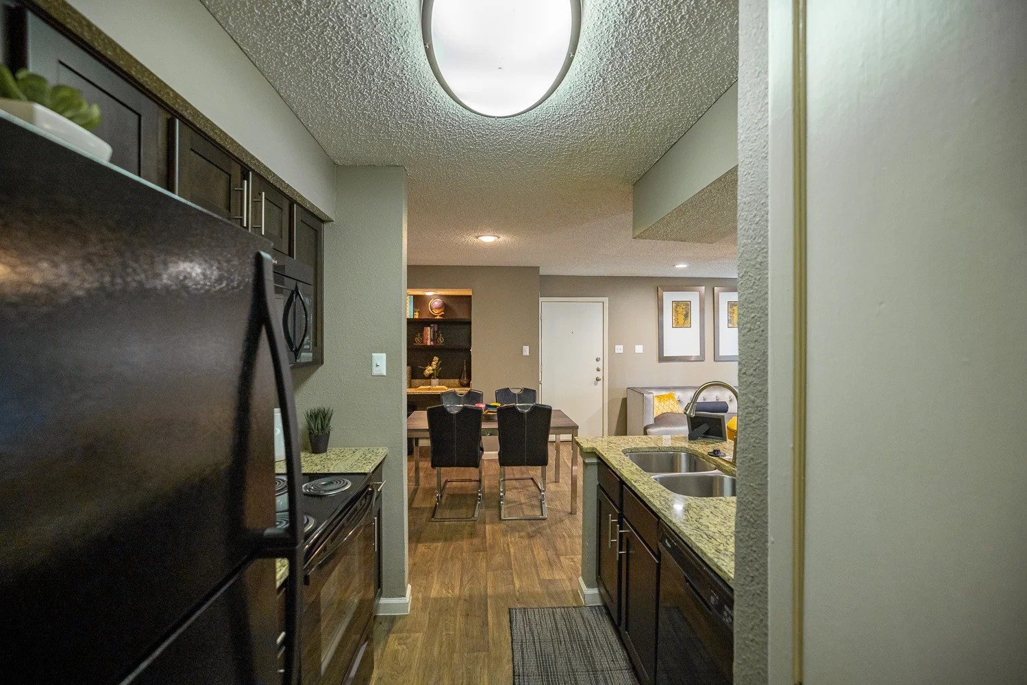 1773 Wells Branch Parkway, Unit 1018 Austin, TX 78728 - Photo 21 of 21 a kitchen with sink refrigerator and cabinets