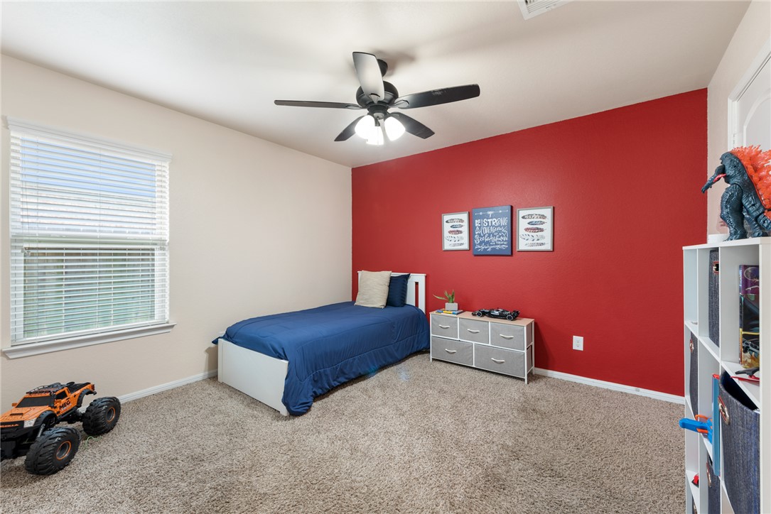 2018 Eagle View Drive Navasota, TX 77868 - Photo 22 of 28 a bedroom with a bed and a chandelier