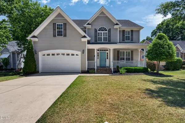 a front view of a house with a yard and garage
