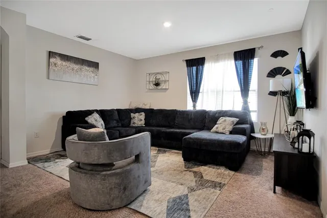 a living room with furniture window and wall painting