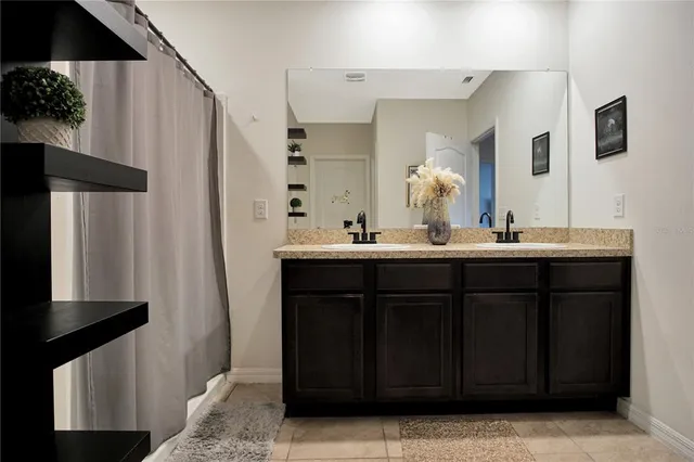 a bathroom with a double vanity sink and a mirror