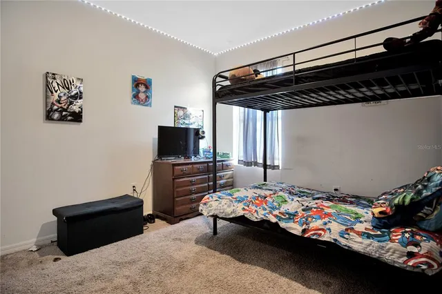 a bedroom with a bed and dresser